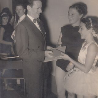 Cyril Johns presenting Desley Hammond with an award at the Creative Art Dancing Contest, Brisbane City Hall 1956.  Courtesy Desley Scott (née Hammond)