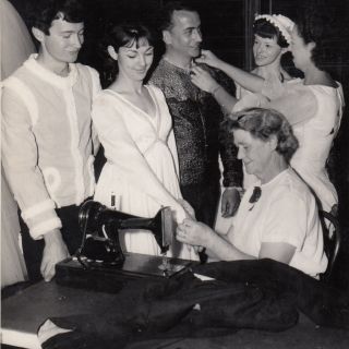Costume fittings L to R: Russell Dumas, Desley Hammond, Donald Kingston, Judith Lowe, Theda Lowe & Mrs Elizabeth Proud seated at the sewing machine. Courtesy Desley Scott (née Hammond)